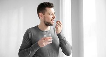 A man takes medication to treat prostatitis