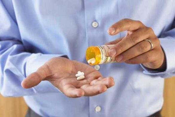 A man takes medication for prostatitis